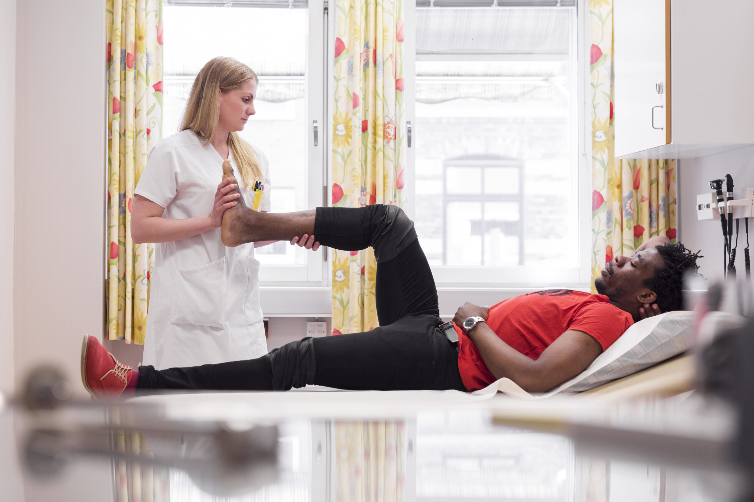Physiotherapist working with patient on rehabilitation exercises